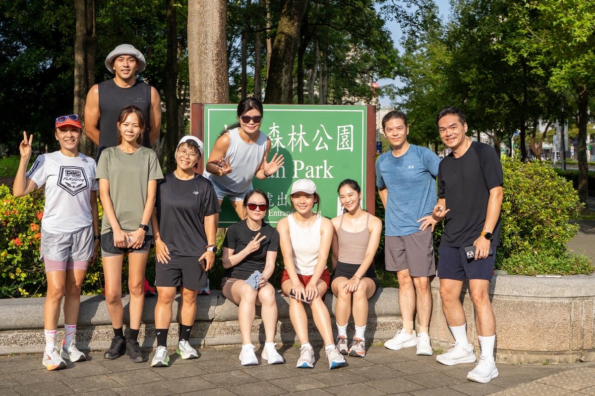 跑者在大安森林公園入口指示牌前合照｜The group posing at the Da'an Park sign
